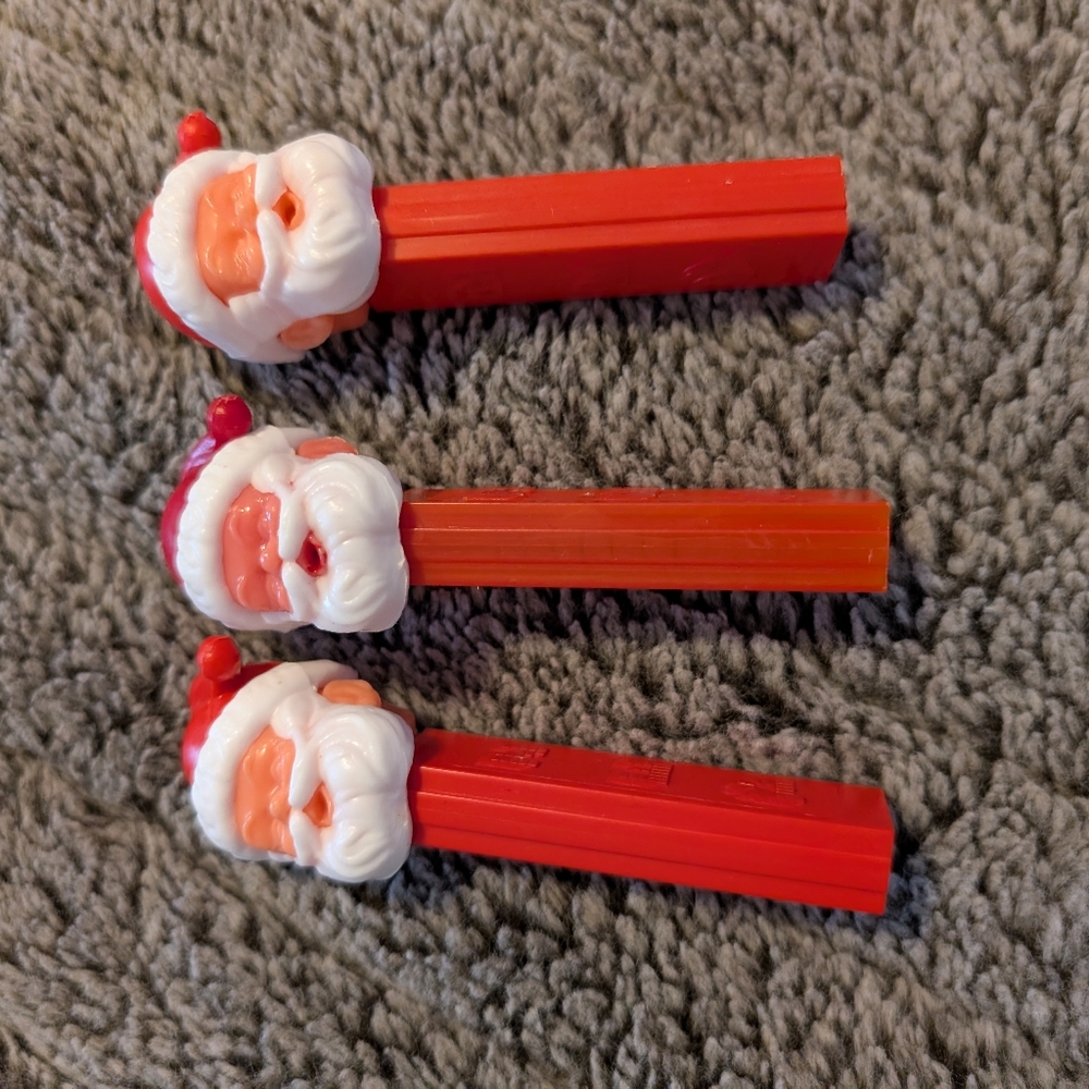Three Santa pez dispensers